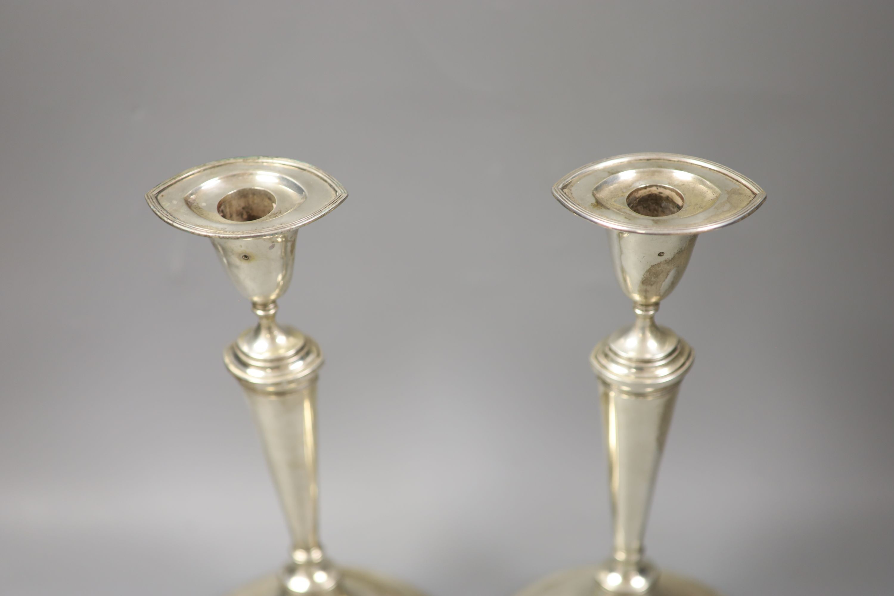 A pair of 19th century Dutch white metal oval candlesticks, 28.1cm, weighted.